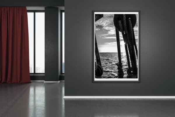 Blank white mock up poster on dark wall in modern living room with wooden floor and red curtain.